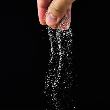 Sprinkling Umami Seasoning Salt with fingers.