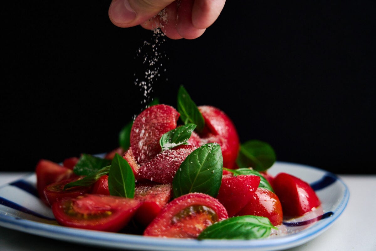 Tomato and basil salad sprinkled with umami salt.