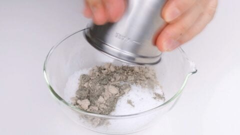 Adding umami powder to salt.