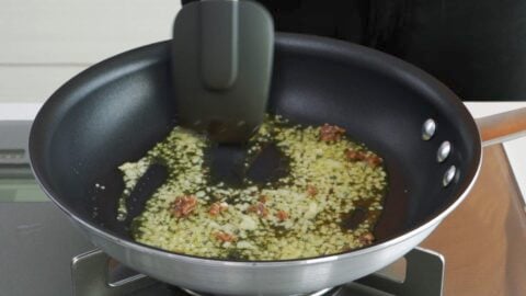 Sauteeing garlic and anchovies in olive oil.