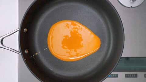 Beaten egg in pan for making Usuyaki Tamago.