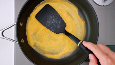 Usuyaki Tamago with spatula in pan.