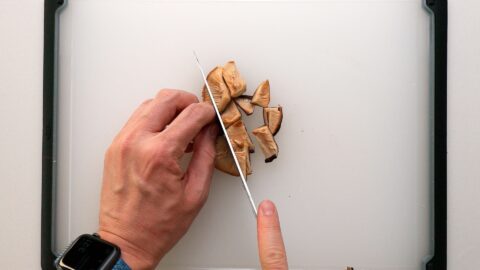 Chopping rehydrated shiitake mushrooms for Vegan Mapo Tofu.