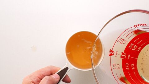 Measuring out shiitake mushroom stock.