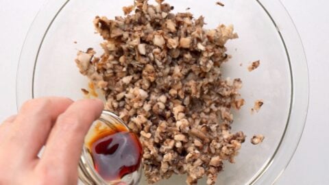 Marinating the ground mushrooms with soy sauce.