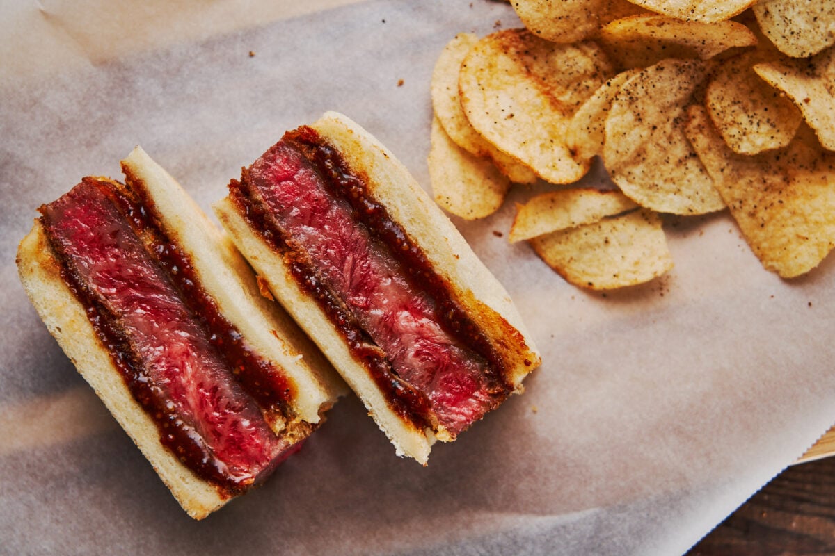 Wagyu Katsu Sando, or Japanese Beef Cutlet Sandwich, is sometimes called the "World's Most Expensive Sandwich," served here with smoked Tellicherry pepper potato chips.