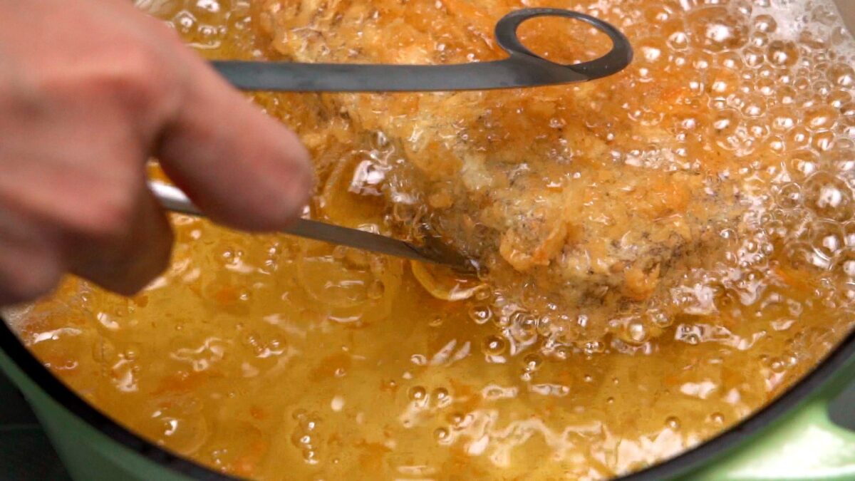 Deep frying Wagyu Katsu in a pot of oil.