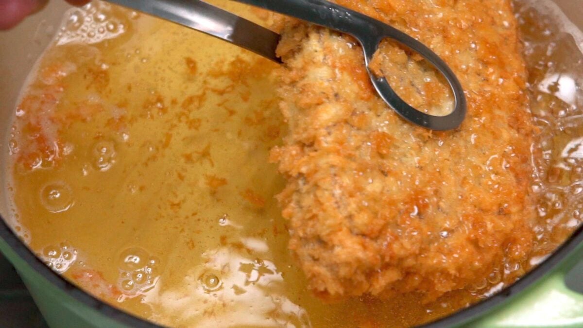 Golden brown wagyu Katsu being removed from a pot of oil.