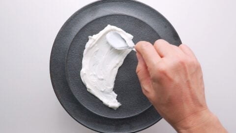 Spreading labneh on a plate.