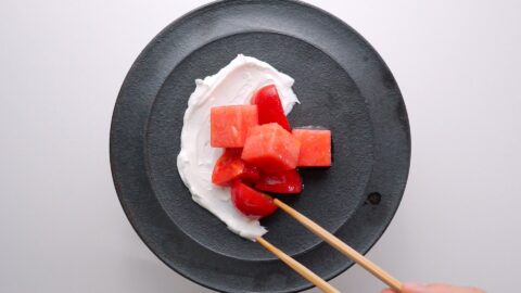 Plating watermelon and tomato salad.