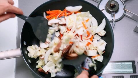 Stir-frying cabbage, carrots, onions and shiitake mushrooms for Yaki Udon.