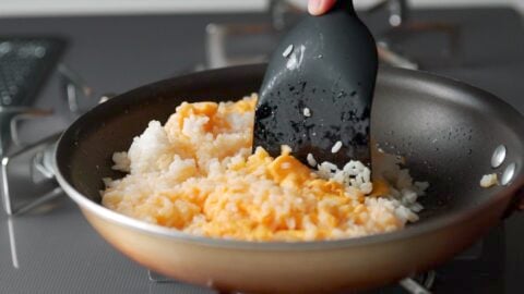 Breaking up clumps of rice and egg to make Yakimeshi.