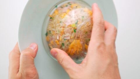 Unmolding a bowl of Japanese fried rice onto a plate.