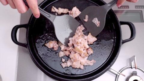 Stir-fry the pork belly until it's starting to brown around the edges.