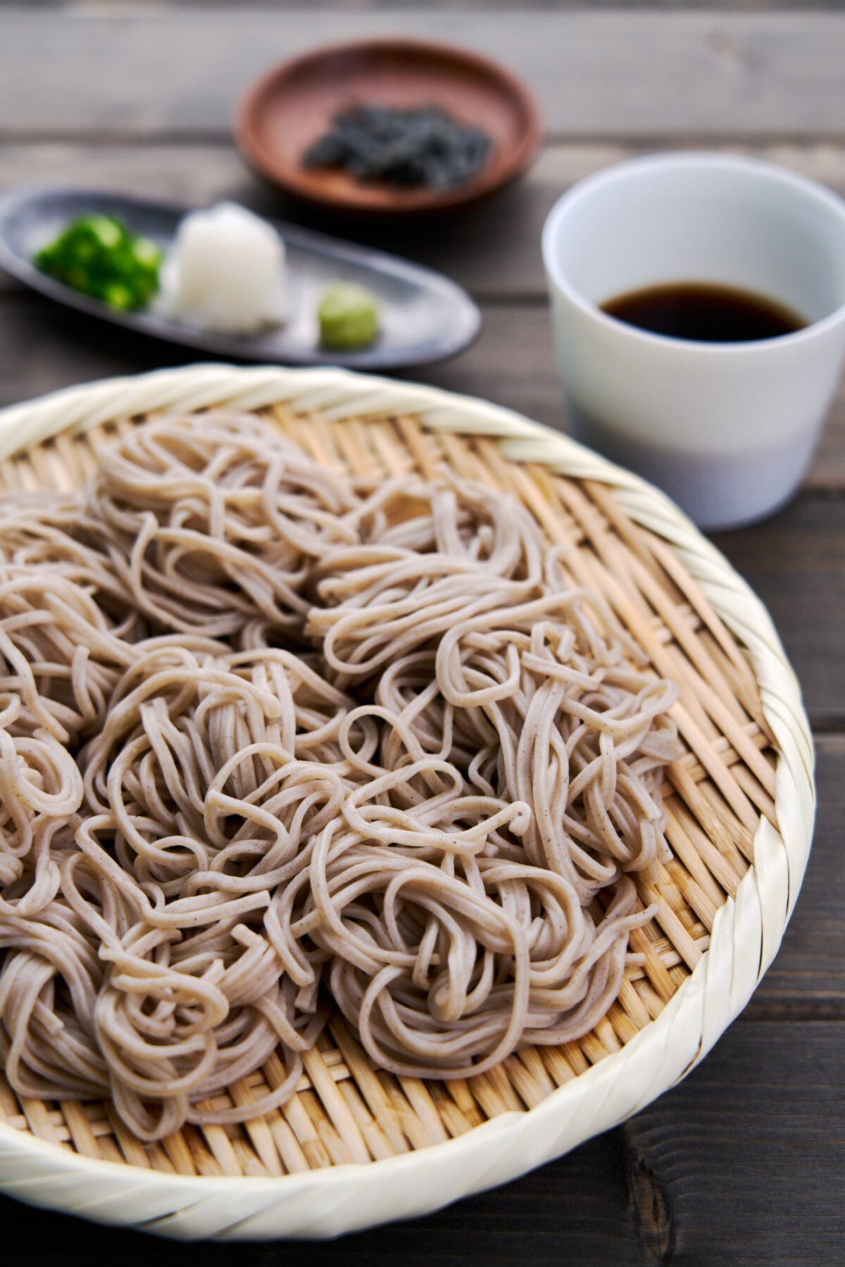 Chilled soba noodles, known as Zaru Soba in Japan is a refreshing summertime meal served with a savory dipping sauce and condiments such as wasabi, scallions, nori and grated daikon.